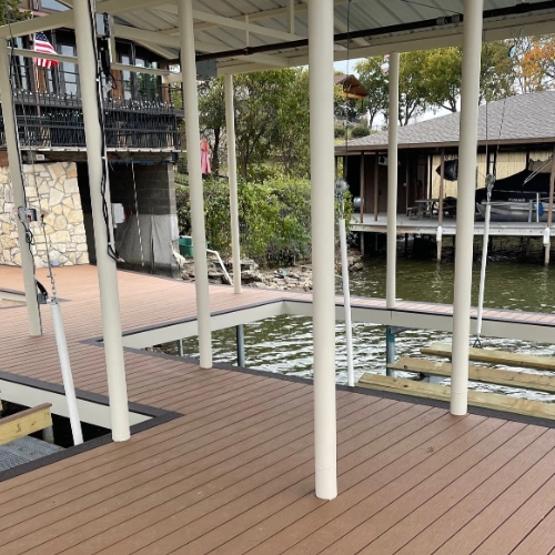 A close-up of the partially built Tahiti dock, highlighting its sturdy steel frame and composite decking. The well-structured layout includes multiple entry points, a boat lift system, and spacious walkways designed for convenience and relaxation.